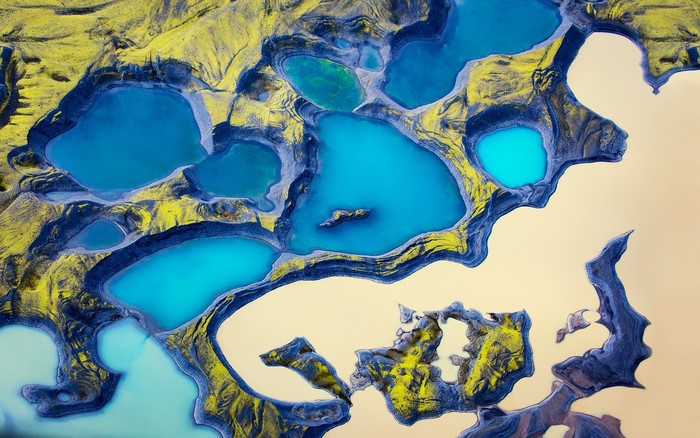 Aerial view of turquoise lakes and yellow hills
