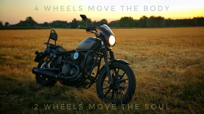 Yamaha XV-950R motorcycle in a field at sunset