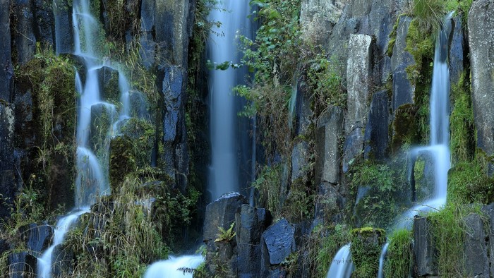 Waterfall cascading over basalt columns in Germany