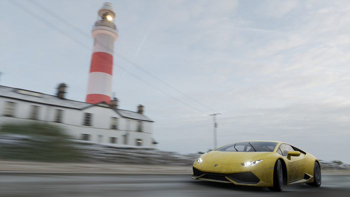 Yellow Lamborghini driving past a lighthouse in Forza Horizon 4