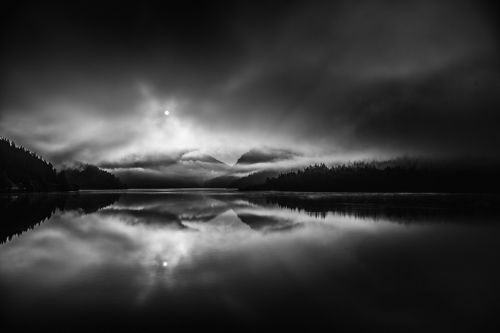 Monochrome lake with mountains and fog