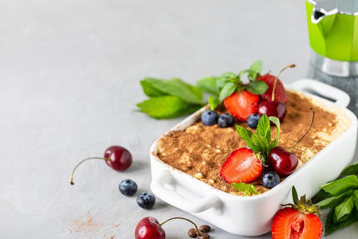 Tiramisu dessert with fresh berries and mint
