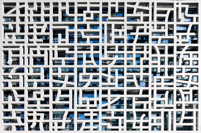 Modern building facade with geometric patterns and glass windows
