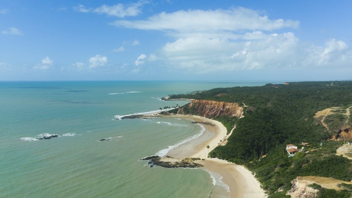 Aerial view of a tropical coastline with cliffs and the sea