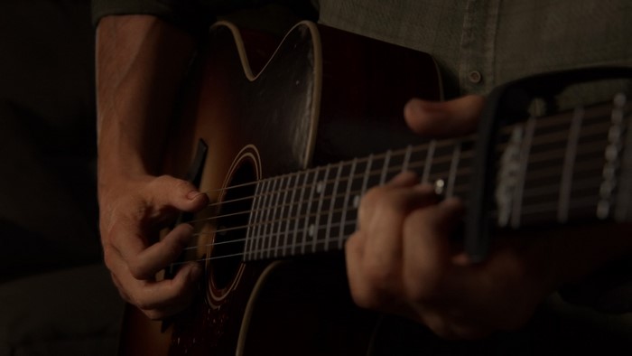 Joel Miller playing guitar from The Last of Us