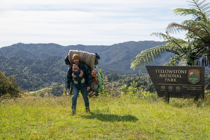 Man carrying baby and gear at Yellowstone National Park