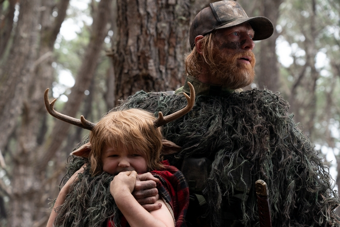 Gus and a man in a forest