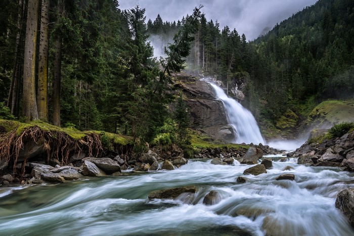 Waterfall in a forest with a river in Austria