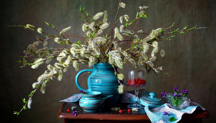 Still life with pussy willow branches and blue pottery
