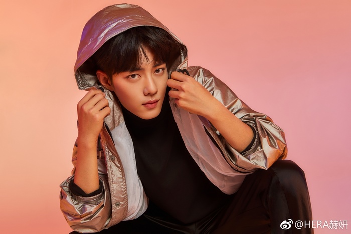Xiao Zhan in a silver hooded jacket