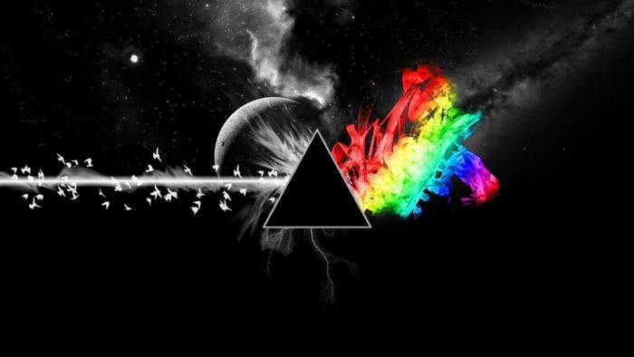 Prism refracting light into rainbow colors with moon and birds