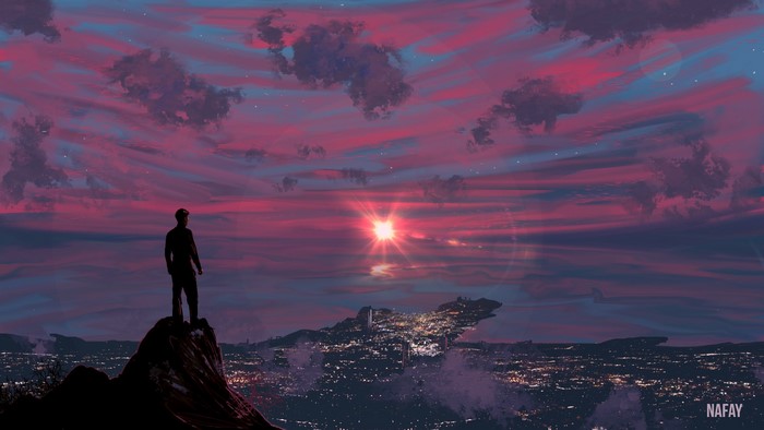 Man on cliff overlooking city at sunset