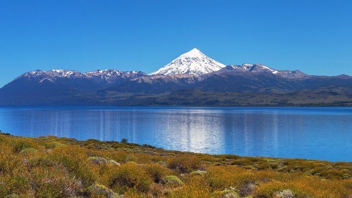 Snowy mountain peak over a blue lake in Patagonia, Argentina