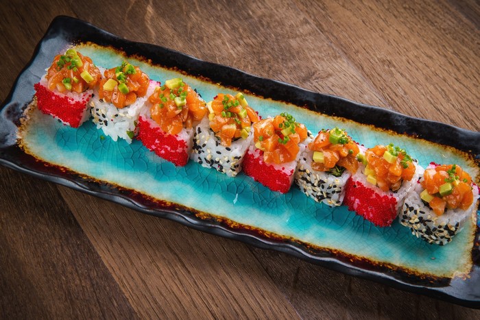 Salmon sushi rolls with caviar and avocado
