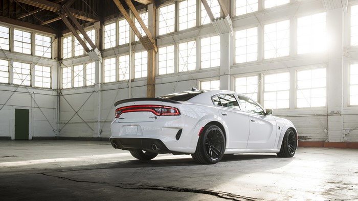 White Dodge Charger Hellcat in a warehouse