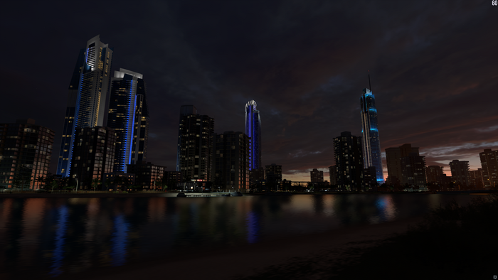 Cityscape at night with lake and skyscrapers