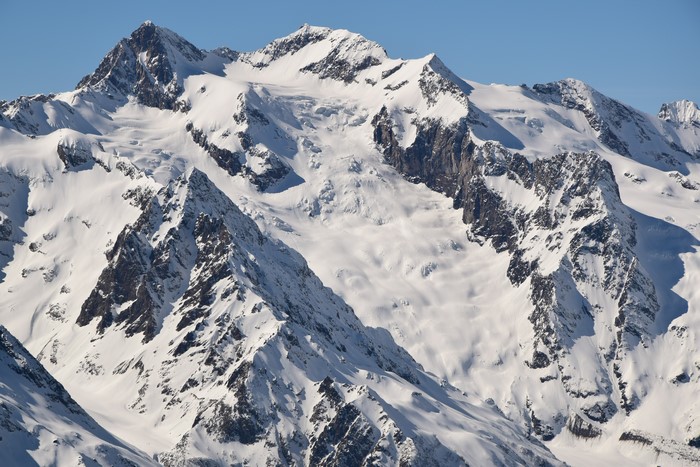4K snow-covered mountains under clear sky