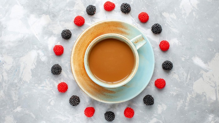 Coffee cup with berries on a marble surface