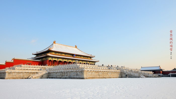 The Forbidden City covered in snow under a clear sky