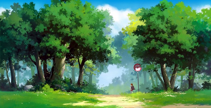 A girl stands on a path in a forest.