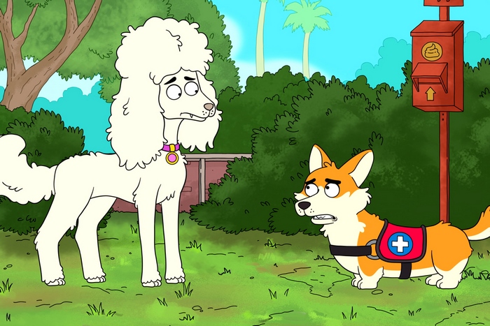 Two dogs in a park with a poop bag dispenser