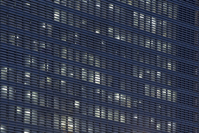 Modern building facade with horizontal louvers and illuminated windows