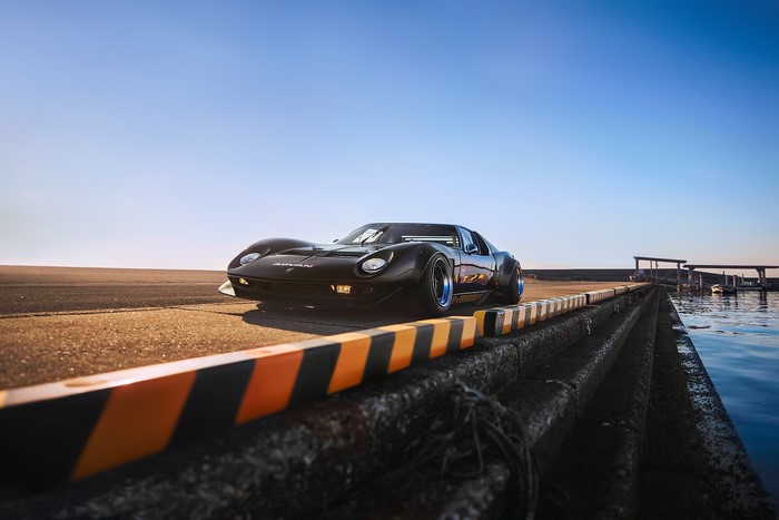 Black Lamborghini Miura with widebody kit on road