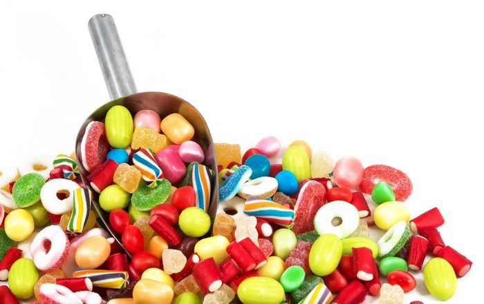 Scoop of colorful candies and sweets