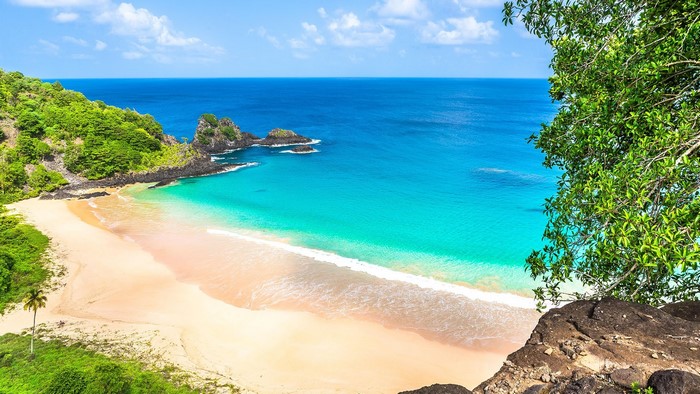 Beach with turquoise water and green hills in Brazil