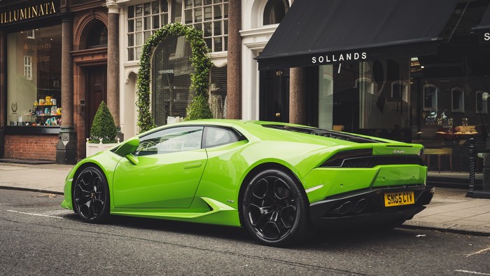 Green Lamborghini Huracan parked on a street