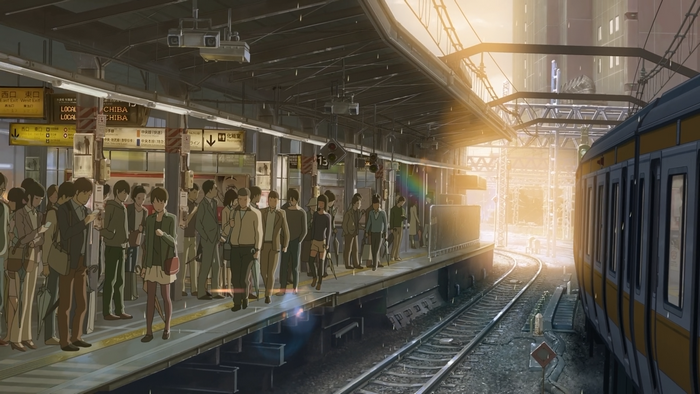 Train station platform with people and train
