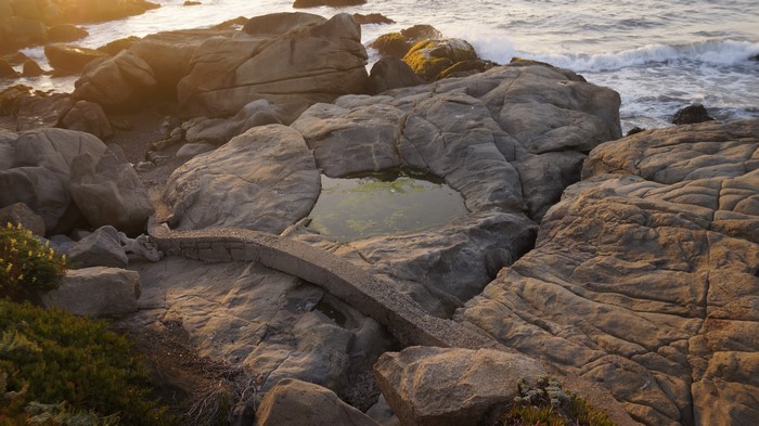 Rocky coastline with tide pool and ocean waves