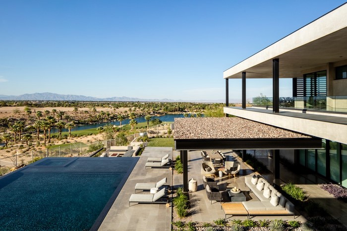 Modern house with swimming pool overlooking golf course and mountains