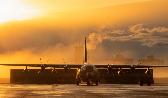 Lockheed MC-130 Transport Aircraft on Tarmac at Sunrise