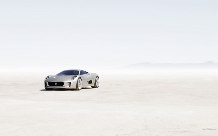 Silver Jaguar C-X75 concept car on a salt flat