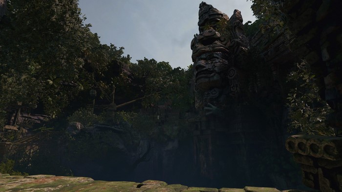Ancient ruins with a stone face in a jungle