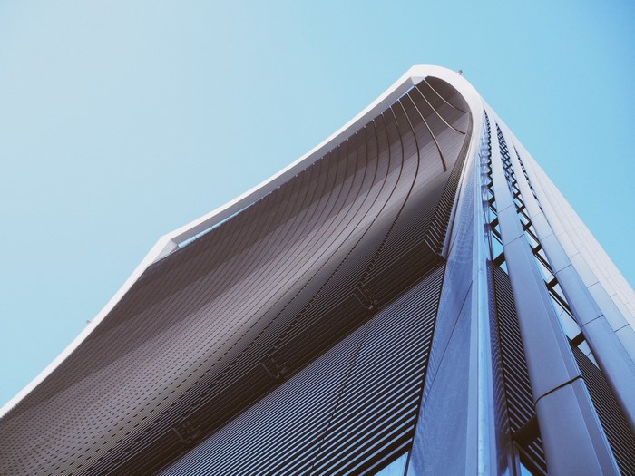 Futuristic skyscraper architecture against a clear blue sky