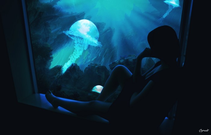Silhouette of a person looking at jellyfish in a dark aquarium
