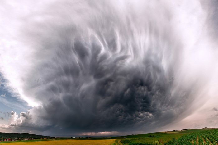 Mammatus clouds over a rural landscape