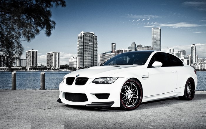 White BMW M3 Coupe by the Sea with City Skyline