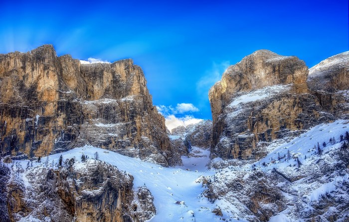 Snowy mountains in the Dolomites under a blue sky