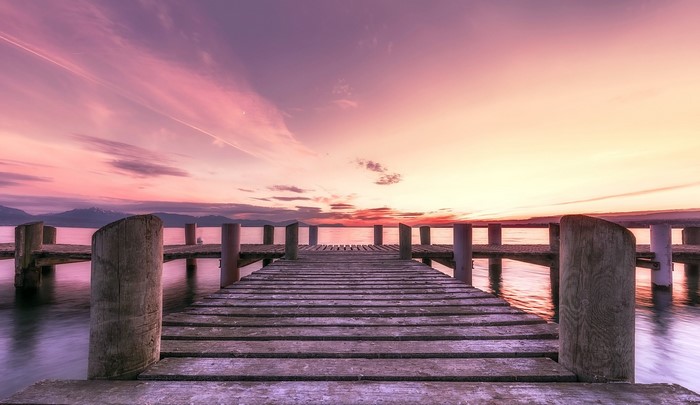 Wooden pier on a lake at sunset