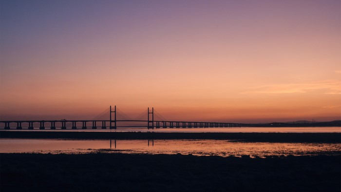 Bridge over water at sunset
