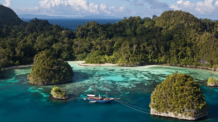Sailboat anchored in a tropical island cove