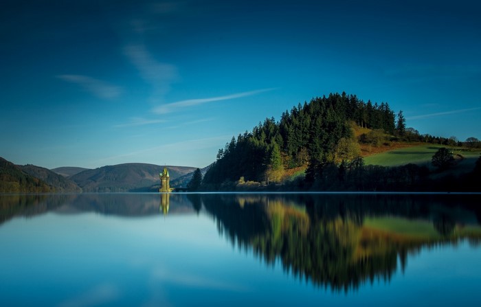 Lake Vyrnwy with tower and forest in Wales