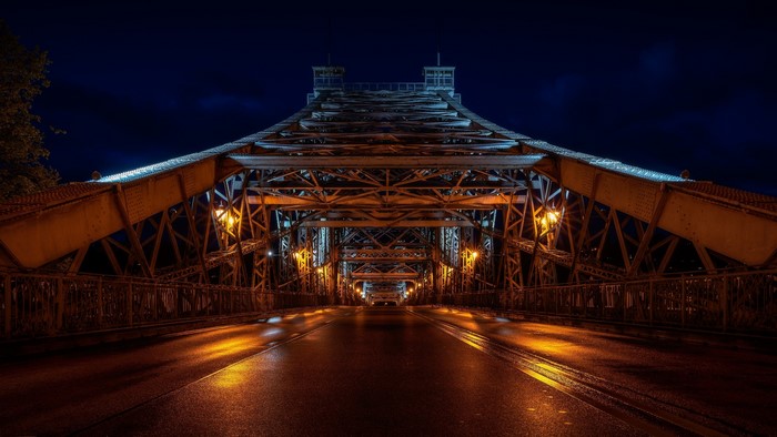 Illuminated bridge at night