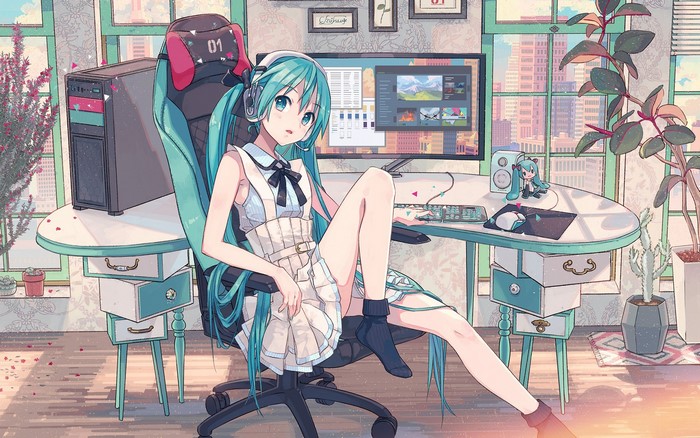 Hatsune Miku sitting at a computer desk