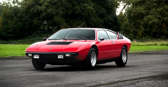 Red Lamborghini Urraco parked on asphalt road
