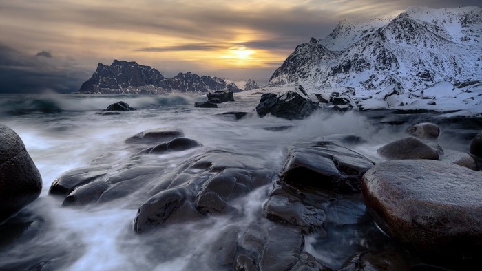 4K rocky coast with waves at sunset