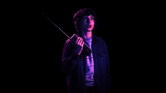Mike Wheeler from Stranger Things holding a walkie-talkie